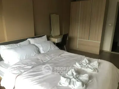 Cozy bedroom with elegant decor and spacious wardrobe in modern apartment.