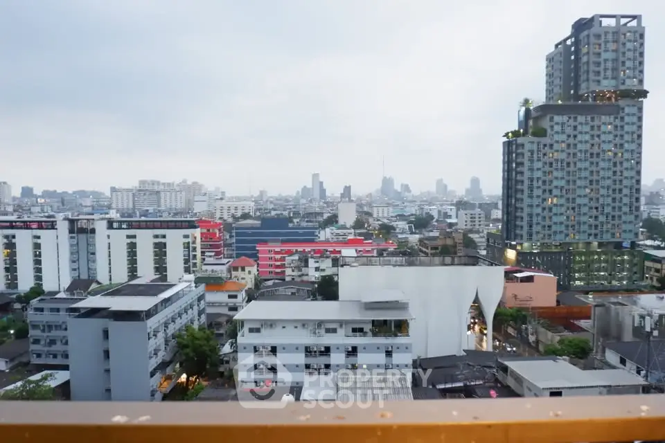 Stunning cityscape view from a high-rise balcony showcasing urban skyline and modern architecture.
