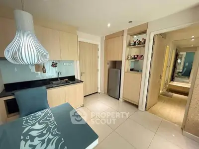 Modern kitchen with sleek cabinetry and stylish lighting in a cozy apartment.