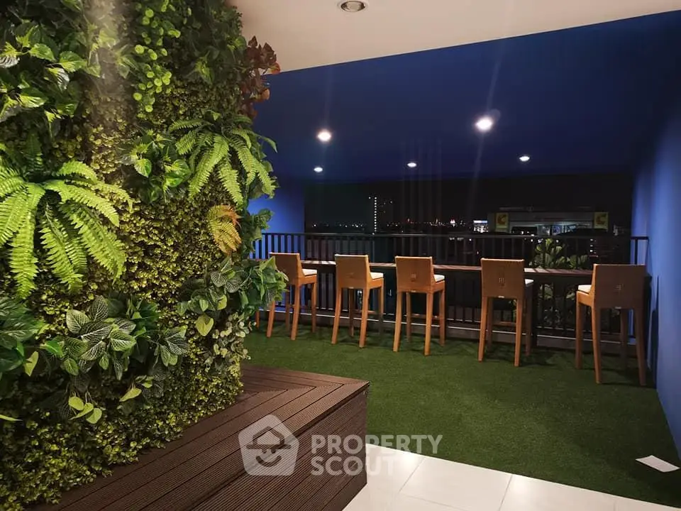 Stylish balcony with lush vertical garden and city view, perfect for relaxation and entertaining.