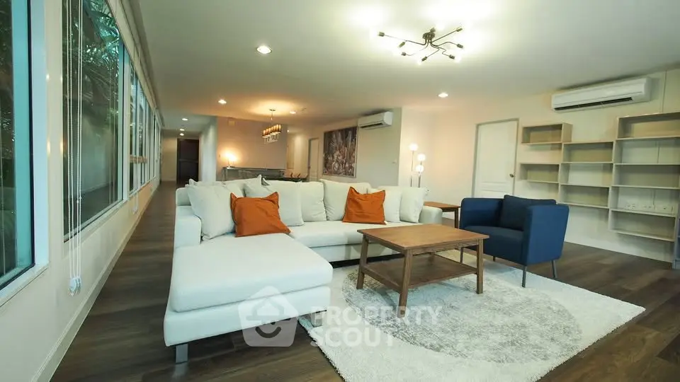 Spacious modern living room with elegant decor and large windows