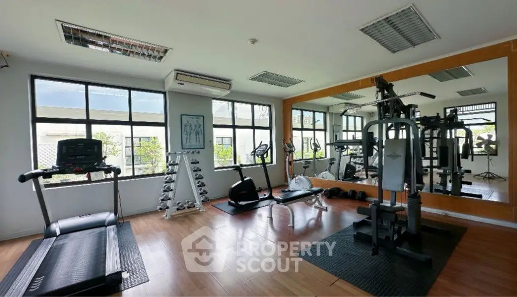 Spacious home gym with modern equipment and large mirrors