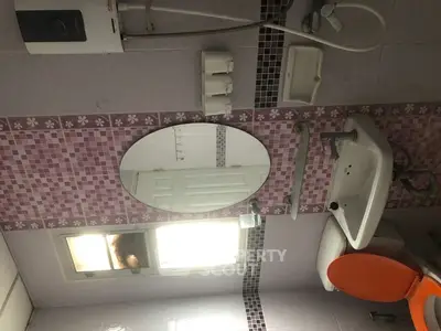 Charming bathroom with modern fixtures and vibrant tile accents, perfect for a cozy home.