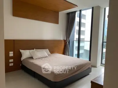 Modern bedroom with large windows and wooden accents in a high-rise apartment.