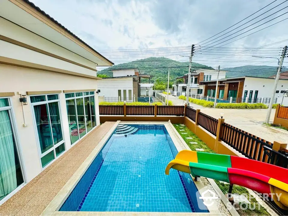 Modern villa with private pool and mountain view in serene neighborhood.