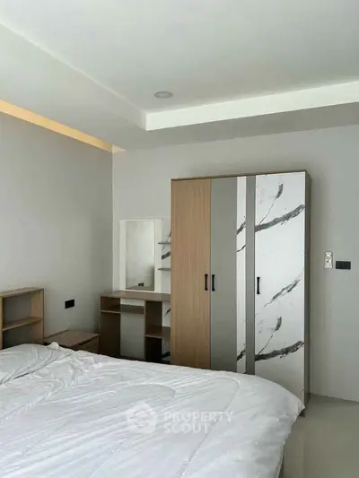 Modern bedroom with stylish wardrobe and cozy bed setup