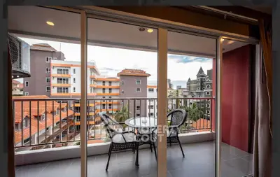 Spacious balcony with city view, perfect for relaxation and outdoor dining.