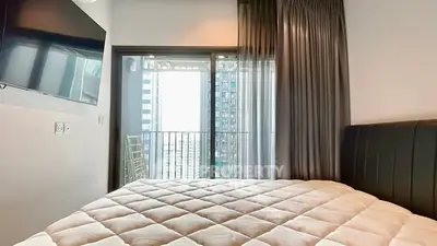 Modern bedroom with balcony view in high-rise apartment