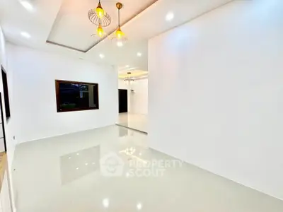 Spacious modern living room with elegant lighting and glossy flooring