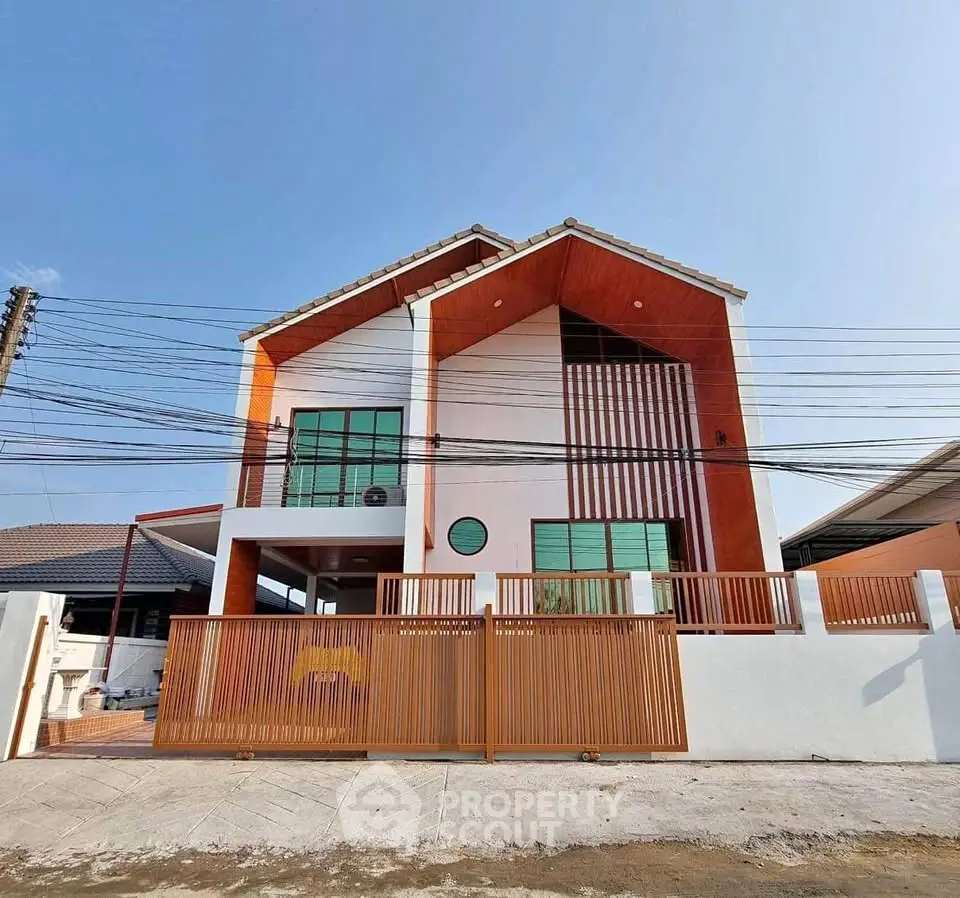Modern two-story house with unique architectural design and spacious front yard