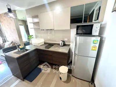 Modern kitchen with sleek cabinetry and stainless steel appliances in a stylish apartment.