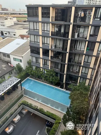 Modern condominium with pool view and cityscape in urban setting