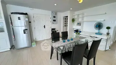 Modern dining area with sleek furniture and stylish decor in a bright apartment.