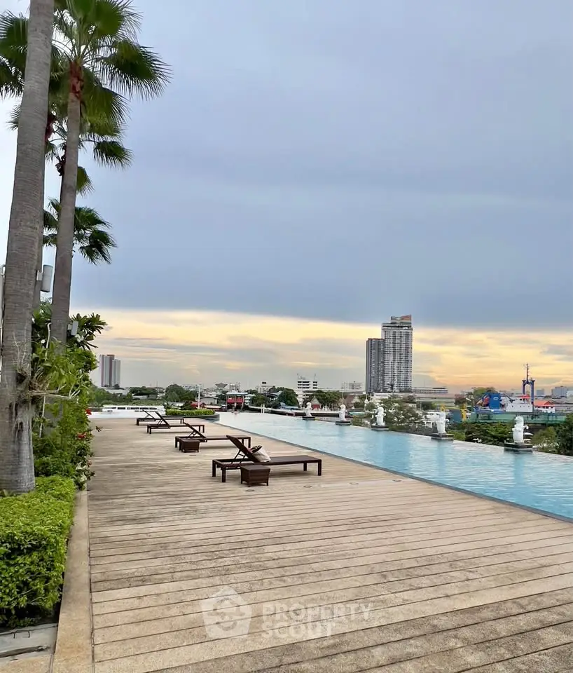 Luxurious rooftop pool with stunning city skyline views and elegant lounge chairs.