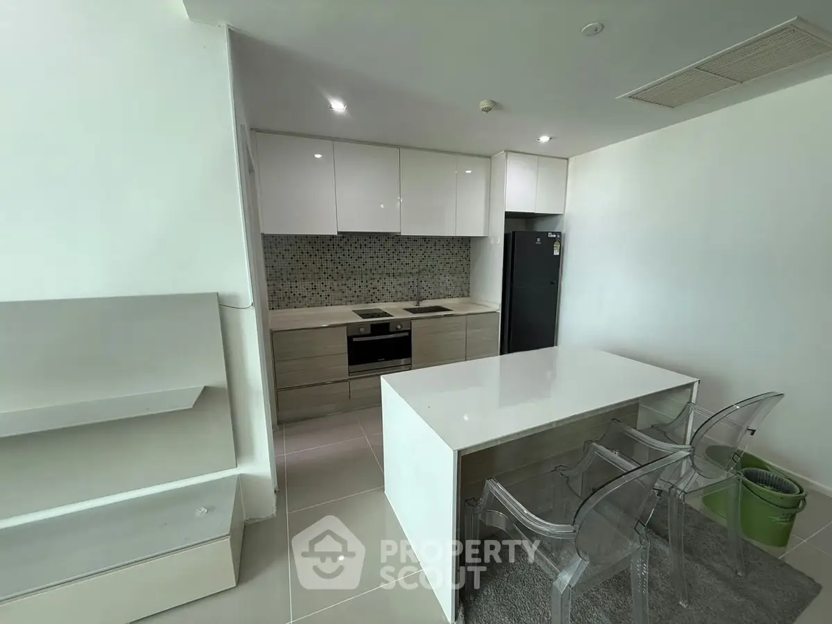 Modern kitchen with sleek cabinetry and island in contemporary apartment