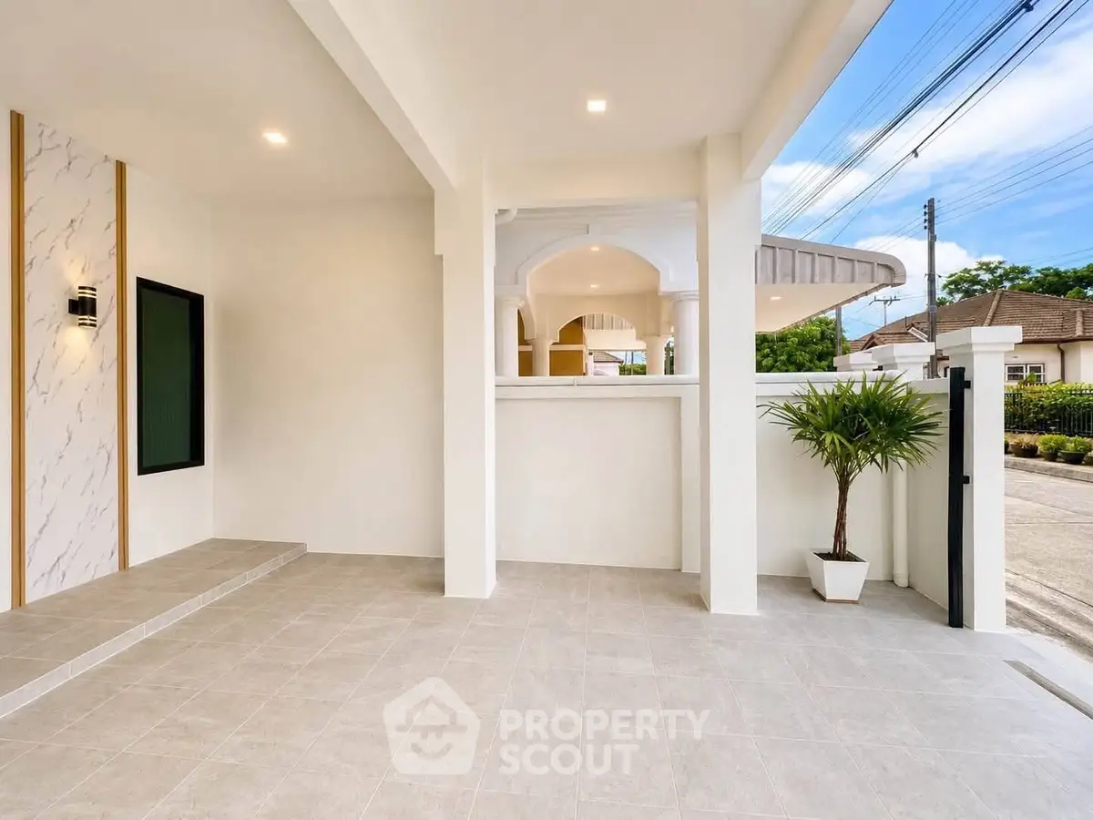 Modern exterior entrance with elegant tile flooring and stylish lighting, perfect for welcoming guests.
