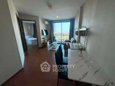 Modern living room with balcony view and stylish furniture in a cozy apartment.