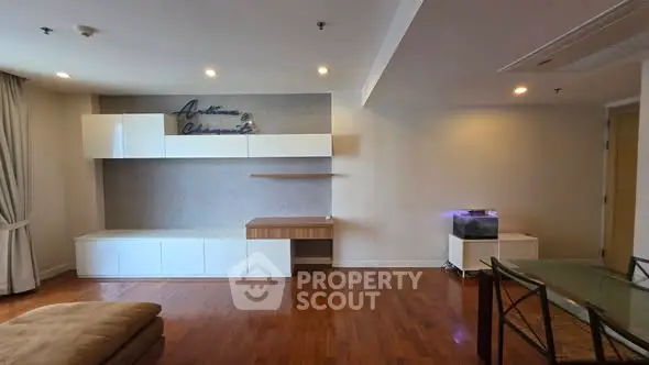 Spacious living room with modern built-in cabinets and hardwood flooring