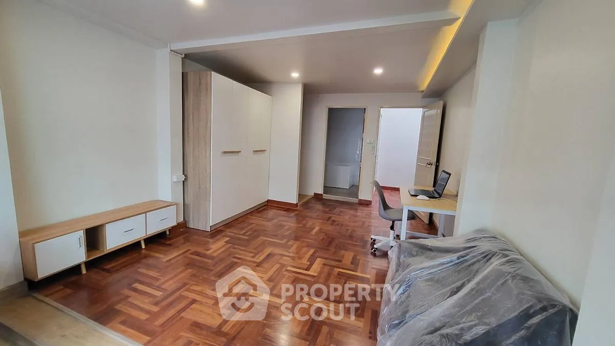 Spacious living room with wooden flooring and modern furniture