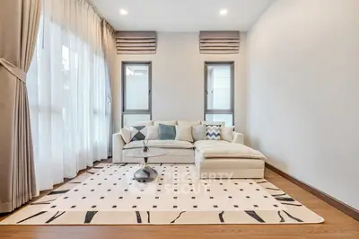 Elegant living room with stylish sofa and large windows, perfect for modern living.