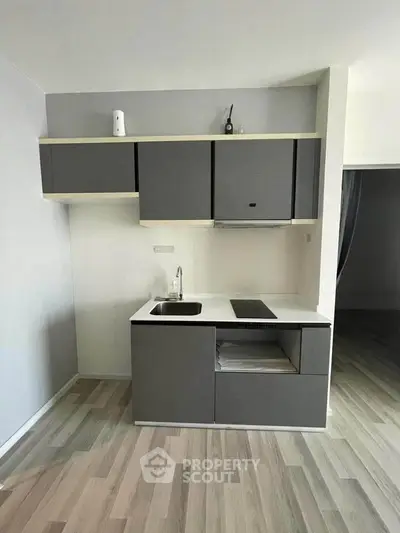 Modern compact kitchen with sleek cabinetry and minimalist design