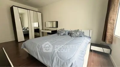 Spacious bedroom with modern furniture and ample natural light