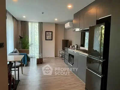 Modern open-plan living room with sleek kitchen and stylish decor