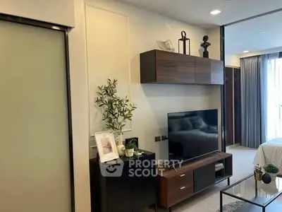 Modern living room with sleek TV unit and stylish decor in a cozy apartment.