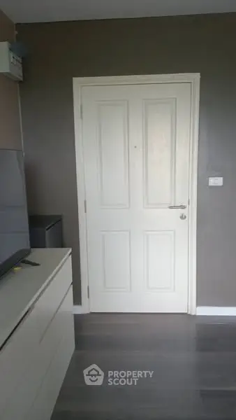 Modern interior with sleek door and stylish flooring, perfect for contemporary living.