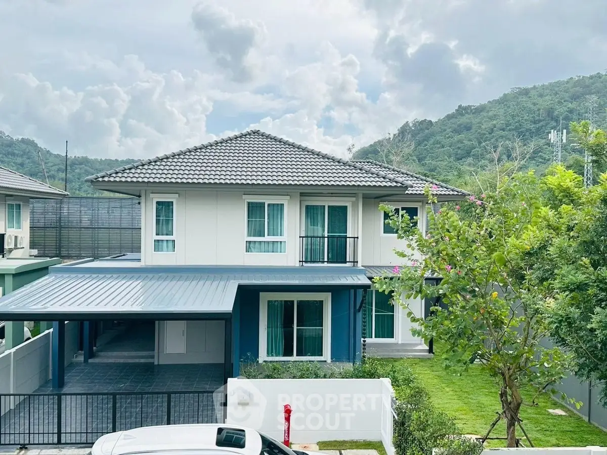 Stunning two-story modern house with lush garden and mountain views, perfect for serene living.