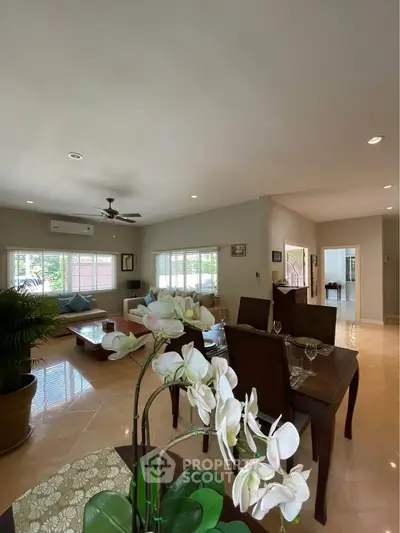 Spacious living room with elegant dining area and natural light