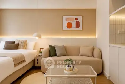Modern bedroom with cozy sofa and stylish decor in neutral tones