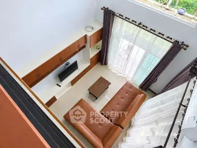 Spacious living room with modern furniture and large windows offering natural light.