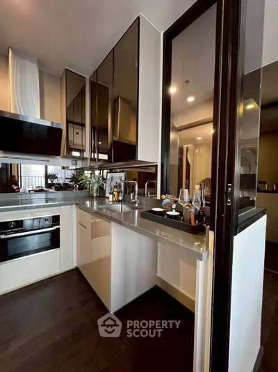 Modern kitchen with sleek cabinetry and built-in appliances, featuring a stylish open layout.