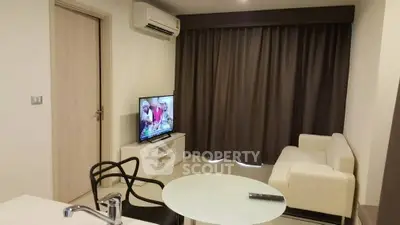 Modern living room with sleek furniture and wall-mounted TV, perfect for relaxation.