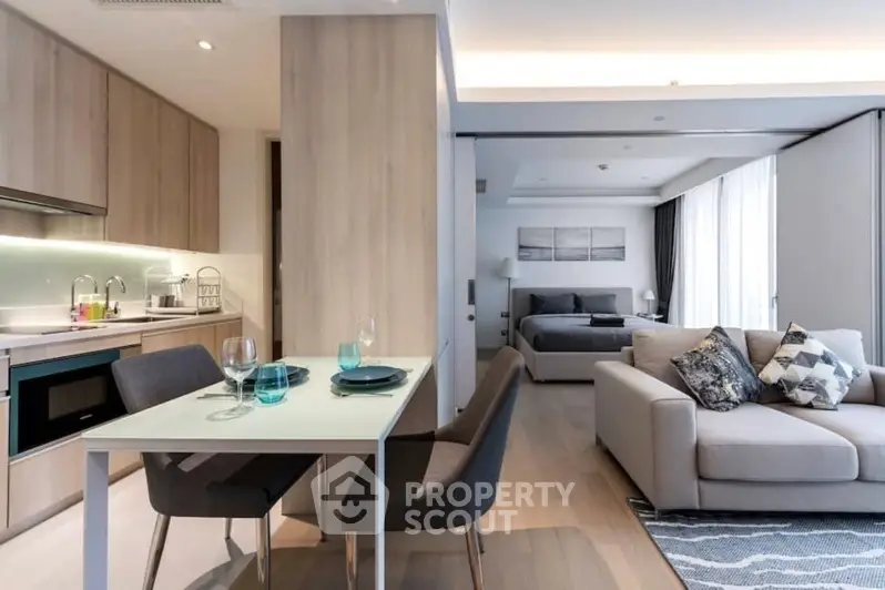 Modern open-plan living room and kitchen with stylish decor and natural light.