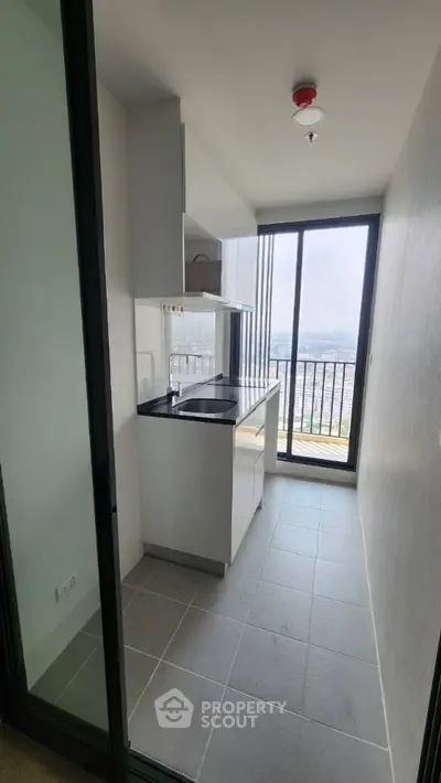 Modern compact kitchen with city view and sleek design
