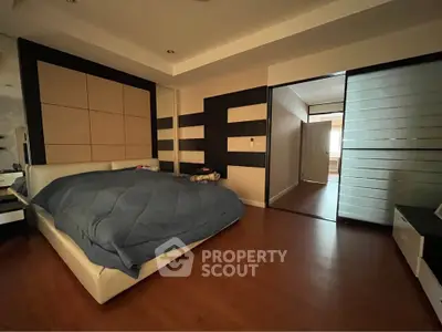 Spacious bedroom with modern design and wooden flooring