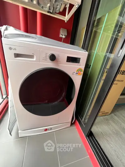 Modern laundry area with energy-efficient LG washing machine in sleek apartment setting.
