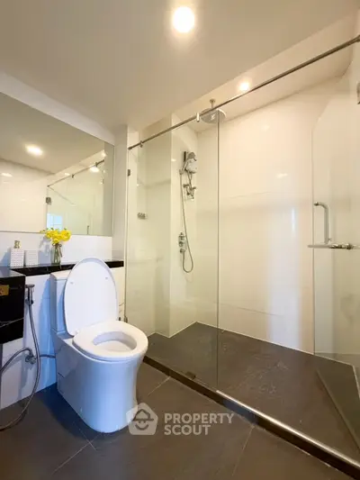 Modern bathroom with glass shower enclosure and sleek fixtures