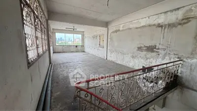 Spacious unfinished room with city view, potential for renovation and customization.