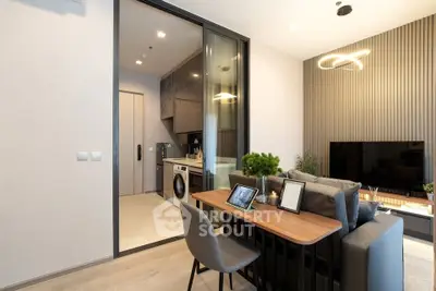 Modern living room with open kitchen and stylish decor in a contemporary apartment.