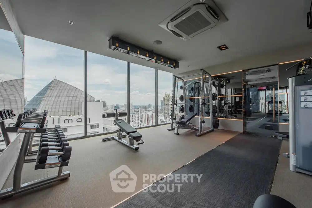 Luxurious high-rise gym with panoramic city views and modern fitness equipment.