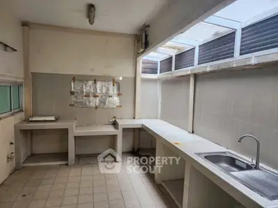 Spacious kitchen with ample counter space and natural light, ideal for culinary enthusiasts.