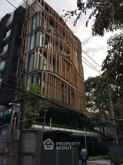 Modern architectural building with unique facade design in urban setting.