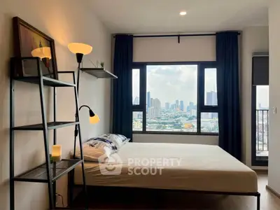 Modern bedroom with city view, featuring stylish decor and large window.