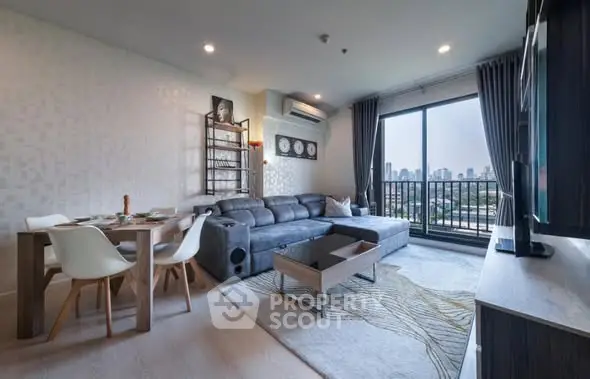 Modern living room with city view, stylish furniture, and large windows for natural light.