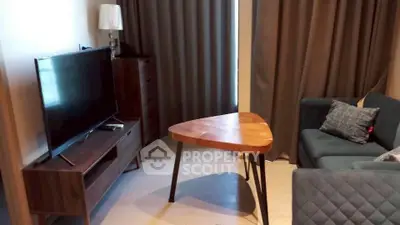 Modern living room with stylish furniture and large TV, perfect for relaxation.