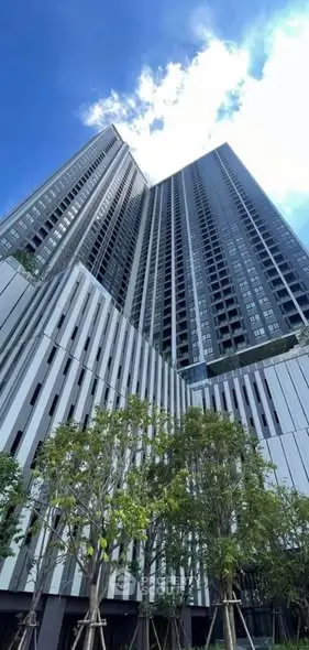 Stunning modern high-rise building with sleek architecture and lush greenery