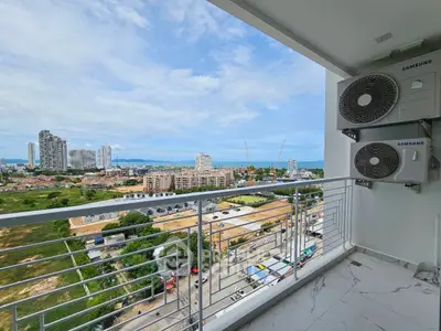 Stunning balcony view overlooking cityscape and distant ocean horizon.